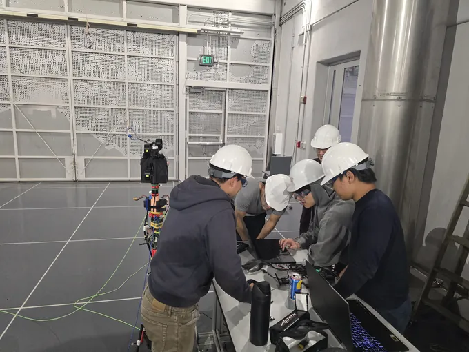 Controls members reviewing flight-test data on laptops